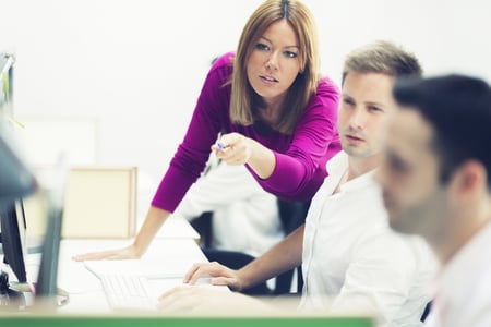 Woman Pointing at Computer