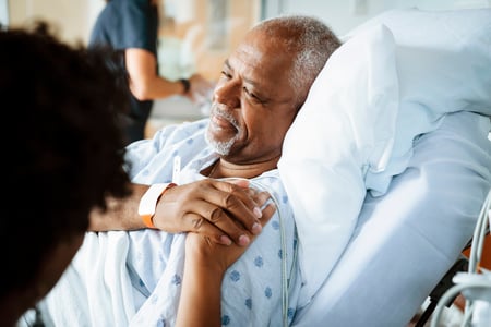 Patient holding hands with other person